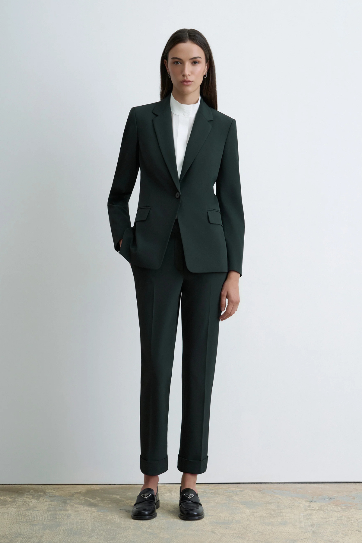 Judith & Charles Russo Pant in deep green, featuring slash pockets, back welt pockets, a hook-and-eye zip closure, belt loops and a cuffed hem.