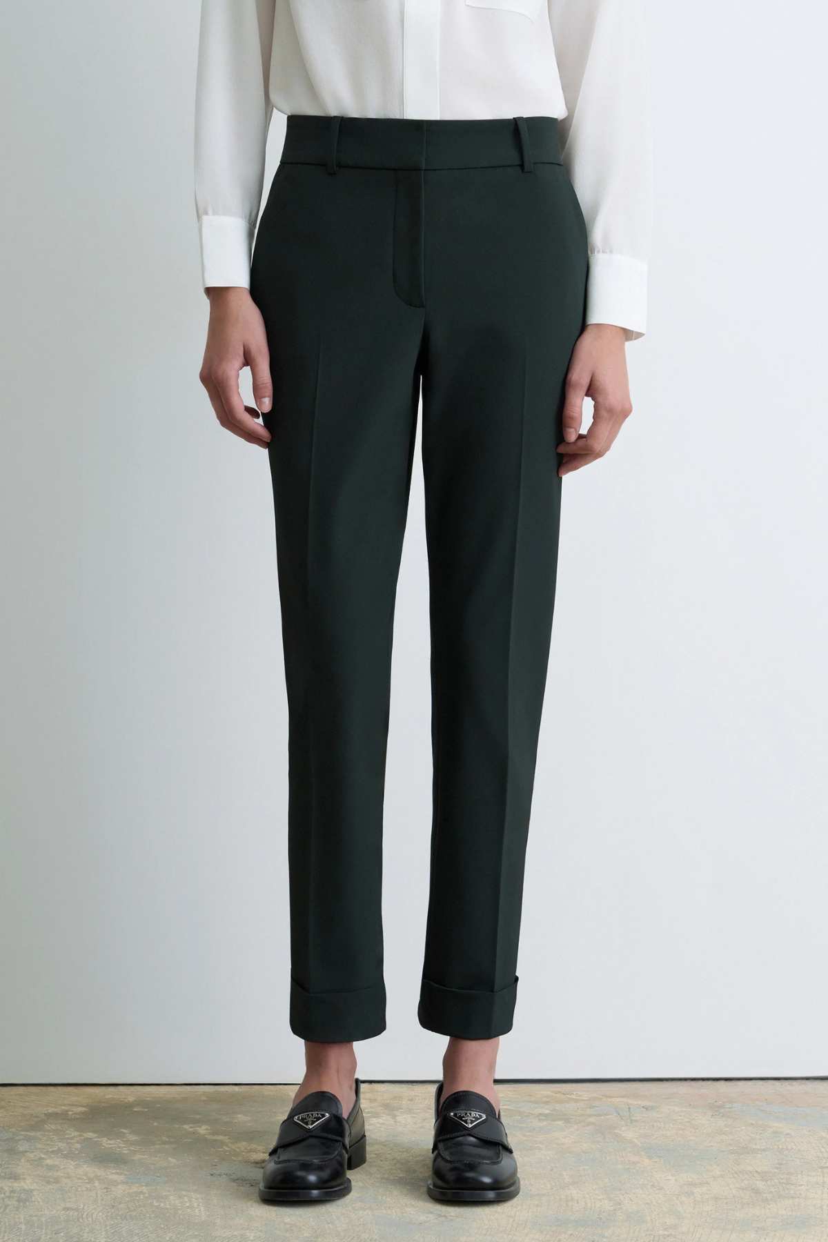 Judith & Charles Russo Pant in deep green, featuring slash pockets, back welt pockets, a hook-and-eye zip closure, belt loops and a cuffed hem.