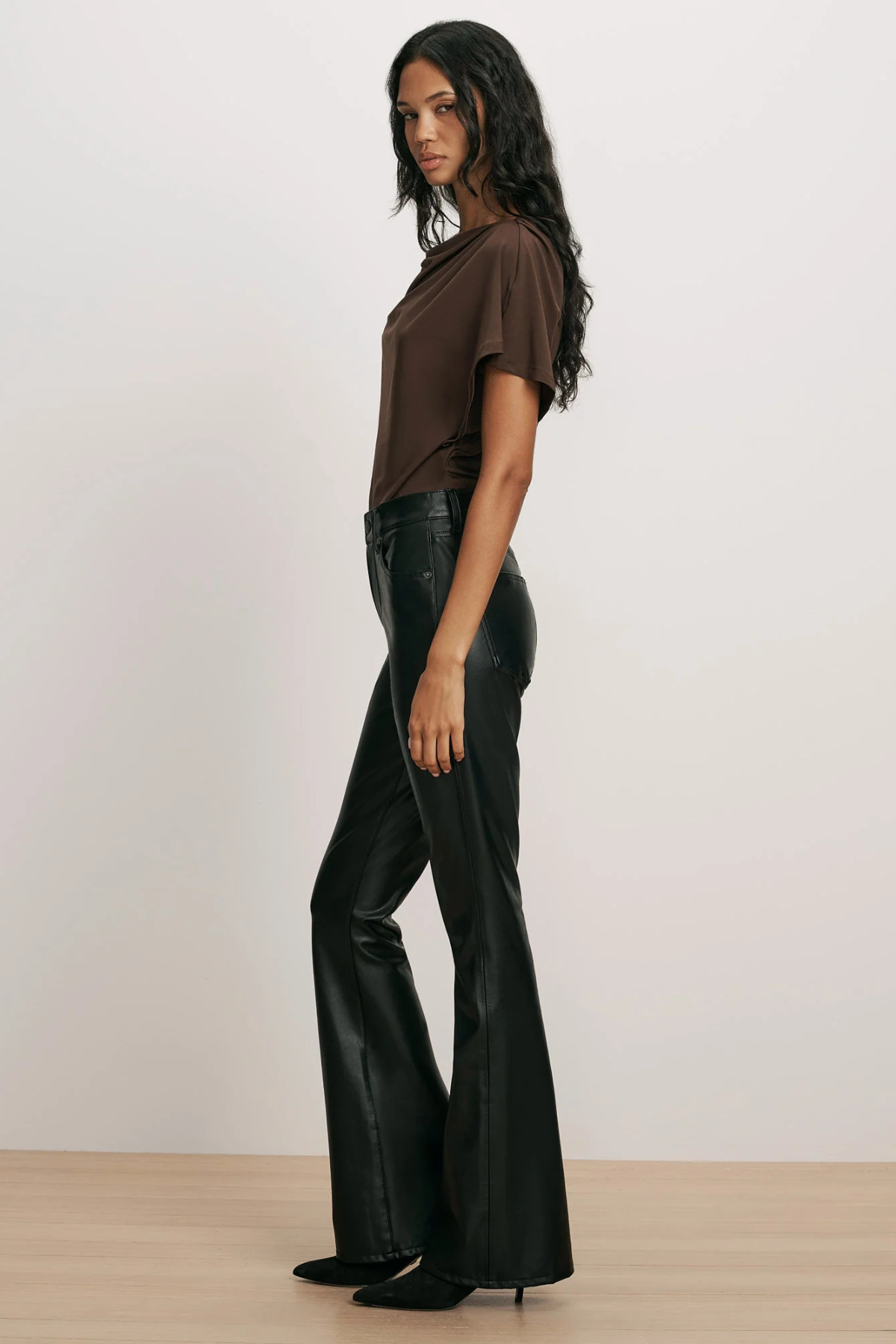 Veronica Beard Beverly High Rise Skinny Flare Pant in black vegan leather, featuring a high-rise waist, front patch pockets and a skinny-flare silhouette.