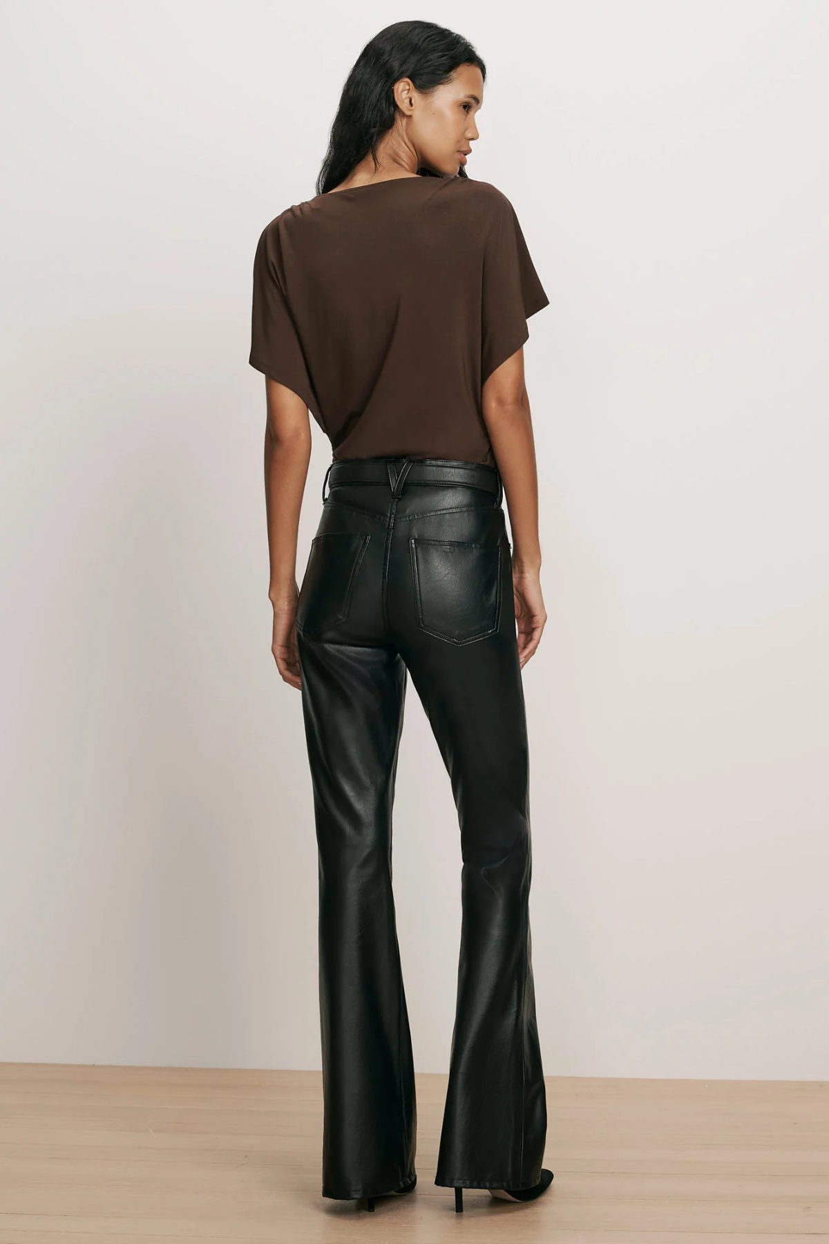 Veronica Beard Beverly High Rise Skinny Flare Pant in black vegan leather, featuring a high-rise waist, front patch pockets and a skinny-flare silhouette.