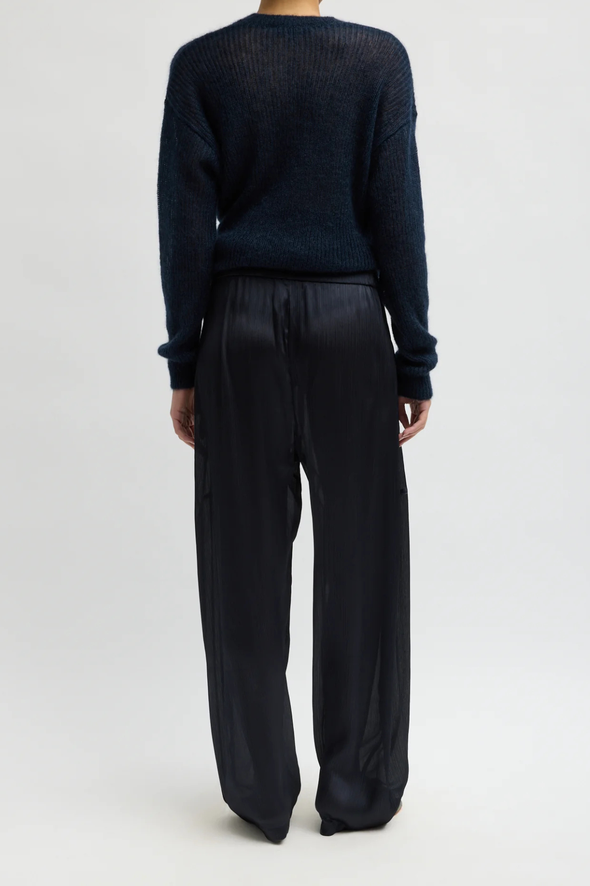 Tibi Matte Satin Plisse Winslow Pant in navy, featuring textured matte satin plissé and a fluid silhouette.