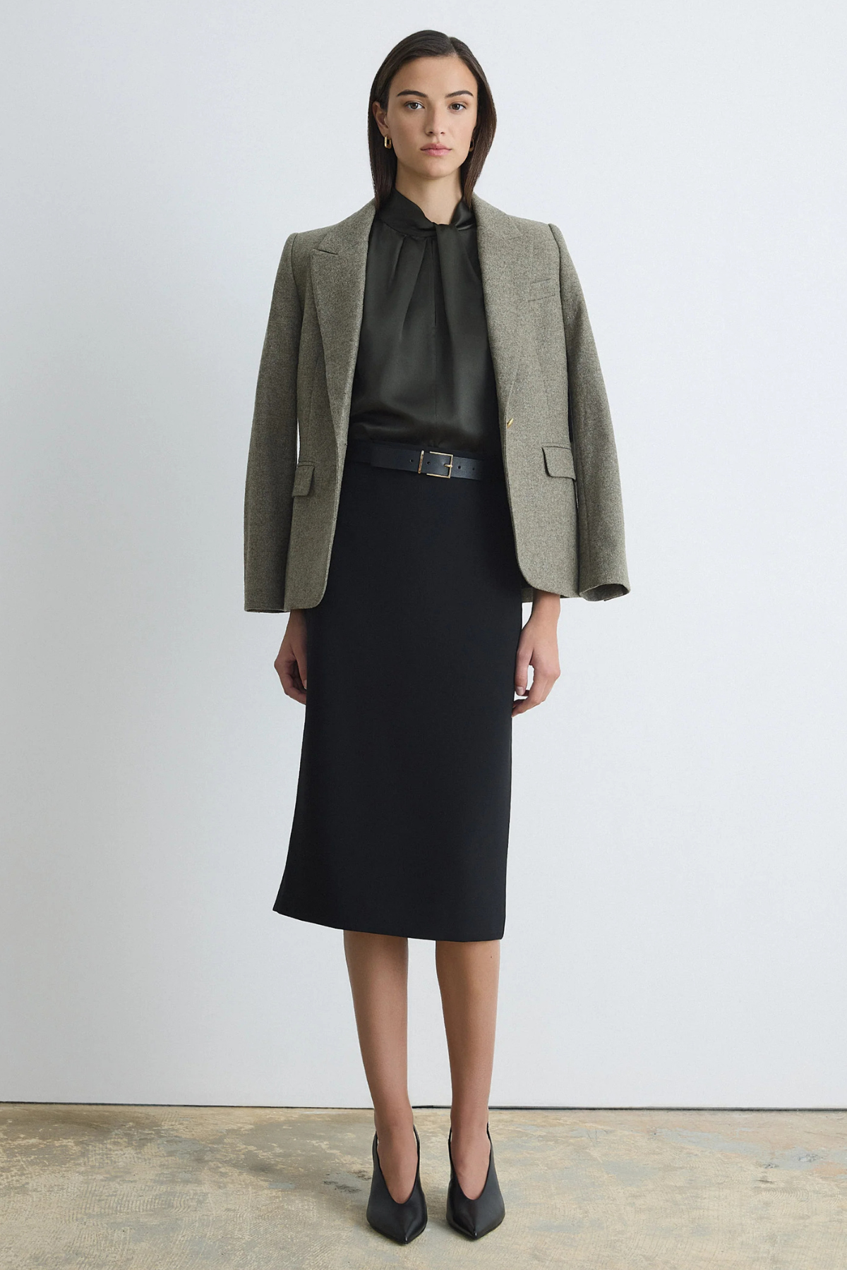 Judith & Charles black pencil skirt with a clean waistband, invisible back zipper, back slit and below-the-knee length.