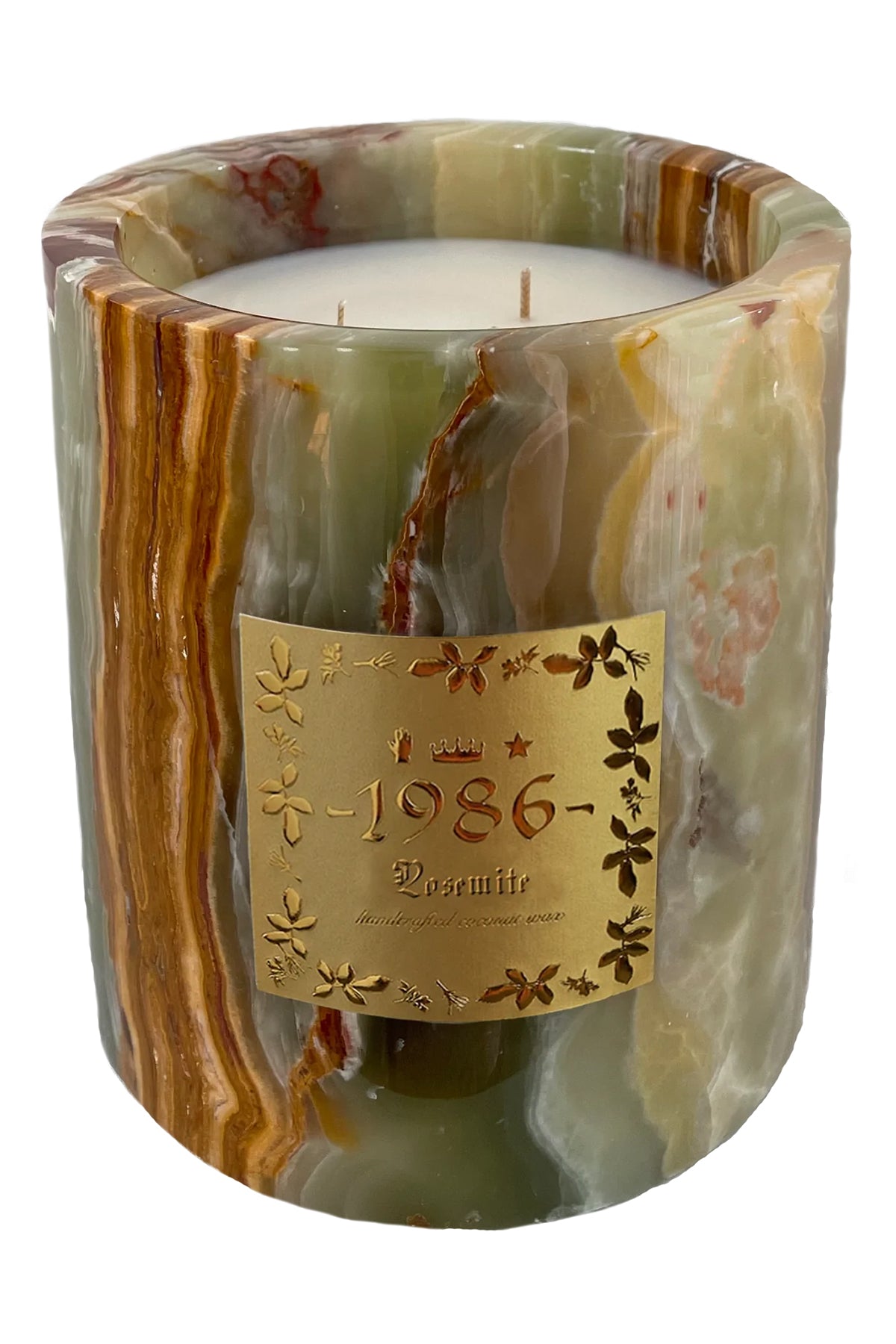 A green marble onyx candle with coconut wax and a cotton wick, featuring a label with '1986' and 'Green Onyx'.