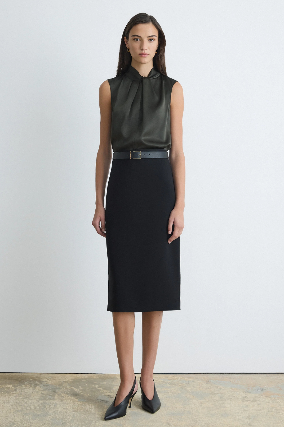 Judith & Charles black pencil skirt with a clean waistband, invisible back zipper, back slit and below-the-knee length.